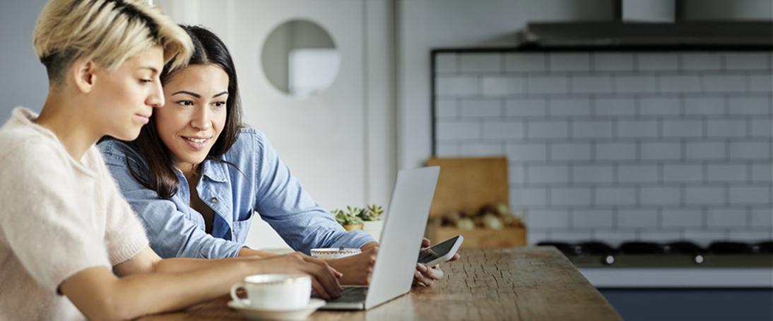 two-women-with-laptop-on-table-welcome-to-hollister-incorporated